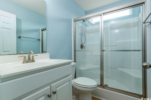 bathroom with vanity, toilet, and an enclosed shower