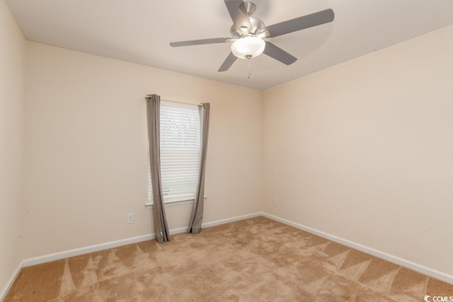 empty room featuring ceiling fan and light colored carpet