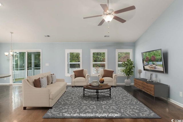 living room featuring vaulted ceiling, dark wood-type flooring, and ceiling fan with notable chandelier