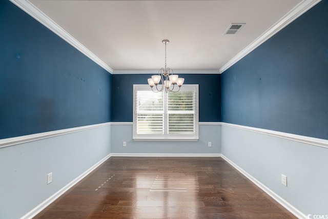 unfurnished dining area featuring crown molding, dark wood-type flooring, and a notable chandelier