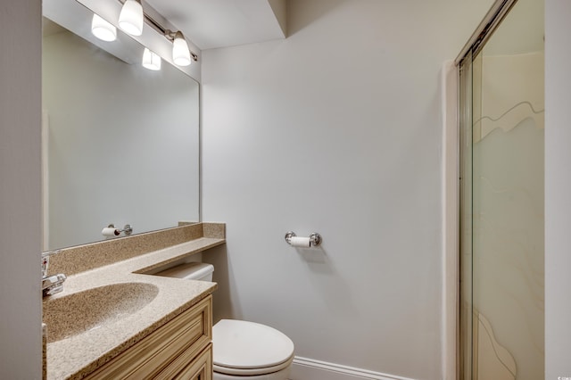 bathroom with toilet, a shower with shower door, and vanity