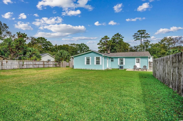 back of house featuring a yard