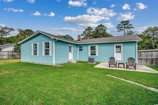 back of house with central AC, a patio, and a yard