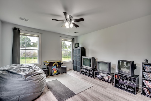 living room with ceiling fan and light hardwood / wood-style floors