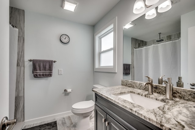 bathroom featuring curtained shower, vanity, hardwood / wood-style flooring, and toilet