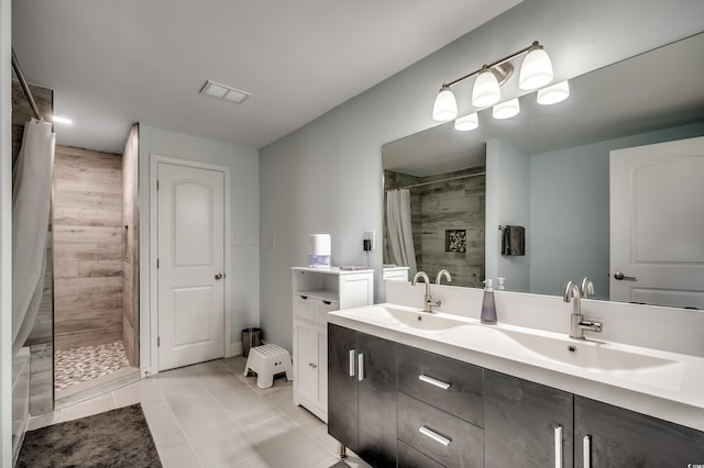 bathroom with walk in shower, tile patterned flooring, and vanity