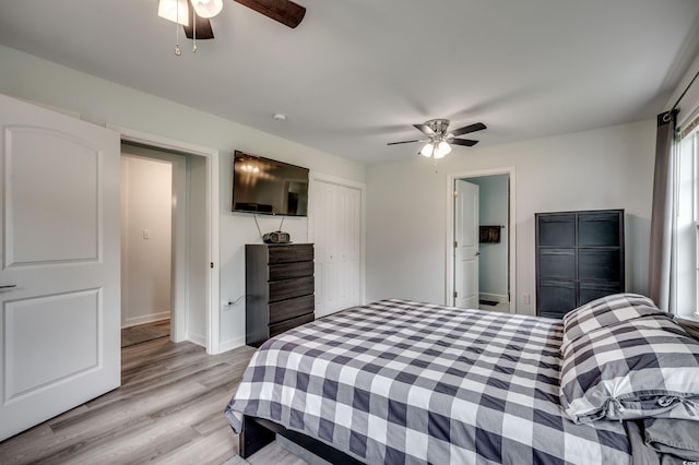 bedroom with ceiling fan, a closet, and light hardwood / wood-style flooring