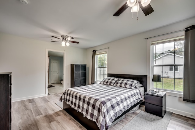 bedroom with light hardwood / wood-style floors and ceiling fan