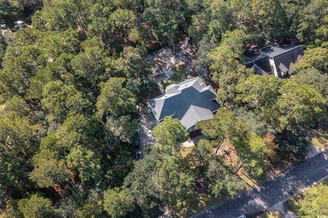 bird's eye view with a wooded view