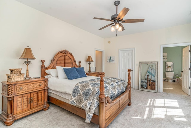 carpeted bedroom with a ceiling fan and ensuite bath