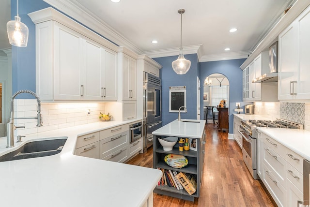 kitchen featuring ornamental molding, high end stainless steel range, light countertops, open shelves, and a sink