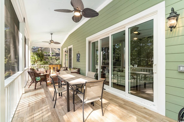 sunroom with lofted ceiling and ceiling fan