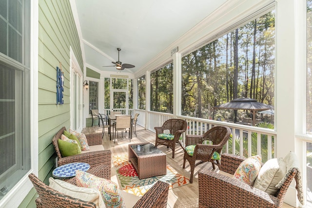 sunroom / solarium with a ceiling fan