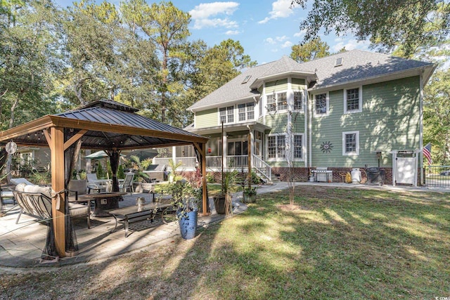 back of house with a patio, a shingled roof, fence, a gazebo, and a lawn