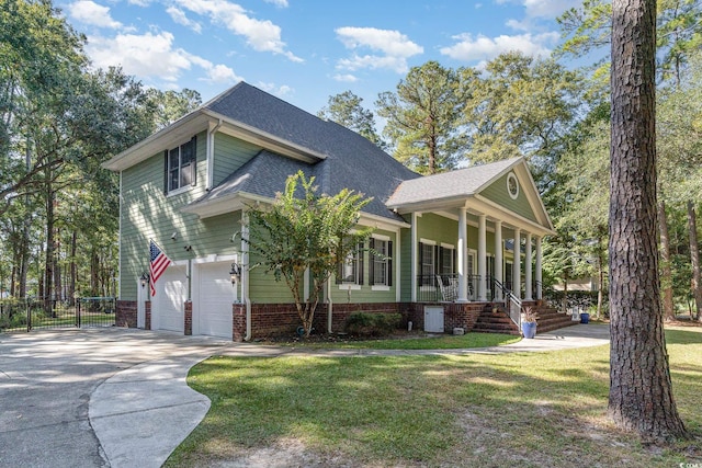 view of front facade with driveway, a porch, roof with shingles, an attached garage, and a front lawn