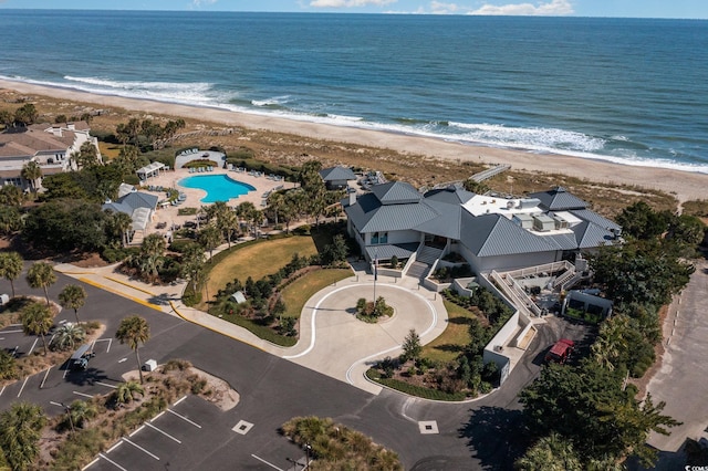 drone / aerial view featuring a water view and a beach view