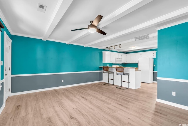 unfurnished living room with ornamental molding, light wood-type flooring, ceiling fan, and beam ceiling