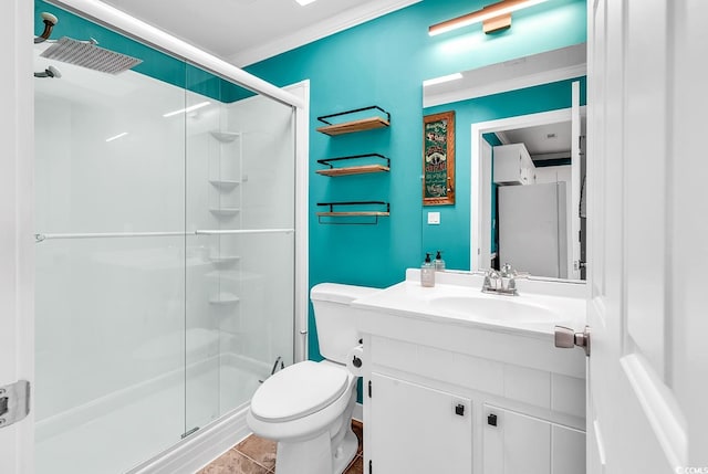 bathroom with tile patterned floors, crown molding, walk in shower, vanity, and toilet