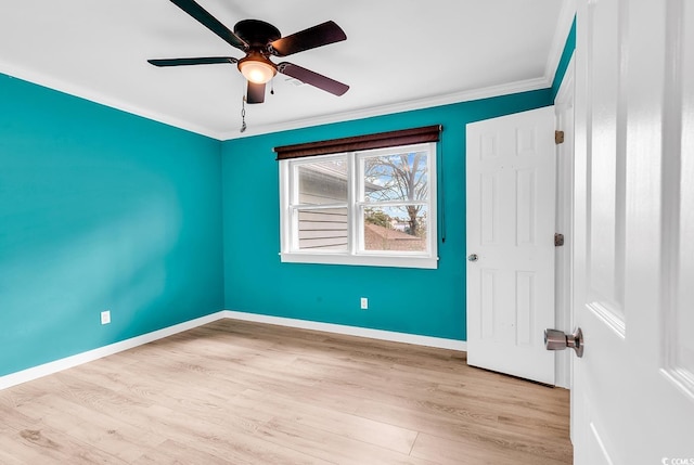 unfurnished room featuring ceiling fan, light wood-type flooring, and ornamental molding