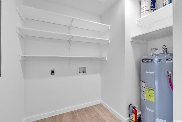 laundry area featuring hookup for an electric dryer, light wood-type flooring, water heater, and washer hookup