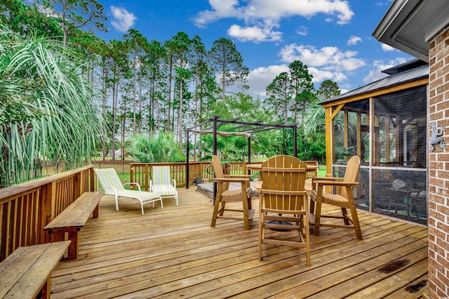 deck featuring a pergola and a sunroom