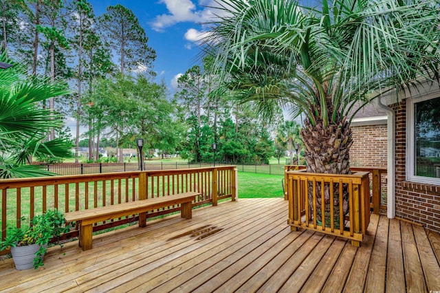 wooden deck with a lawn