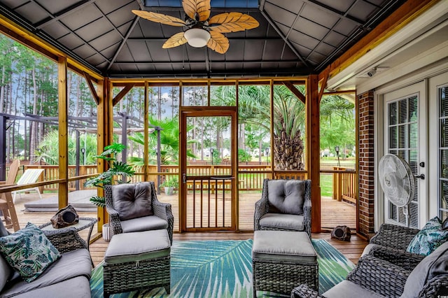 sunroom with ceiling fan and lofted ceiling