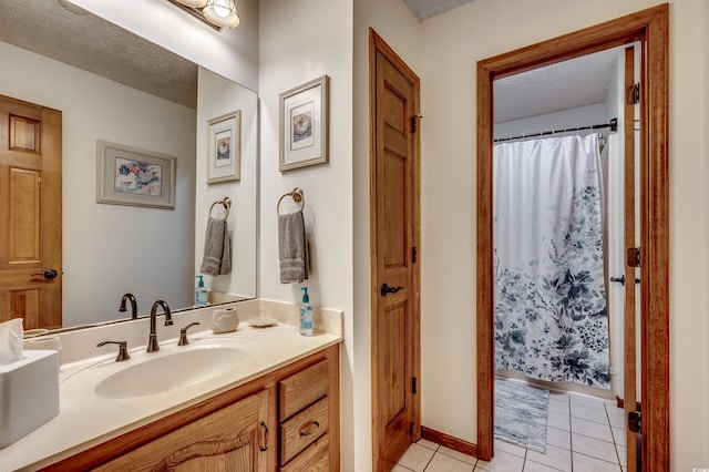 bathroom with vanity, a shower with shower curtain, tile patterned flooring, and a textured ceiling