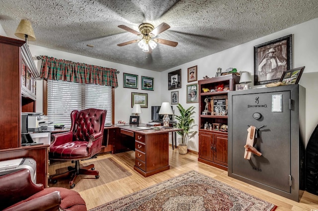 office featuring light hardwood / wood-style floors, ceiling fan, and a textured ceiling