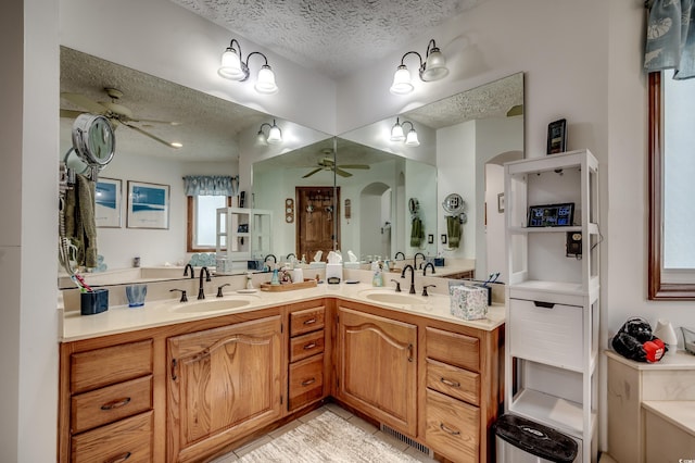 bathroom featuring vanity, a textured ceiling, and ceiling fan