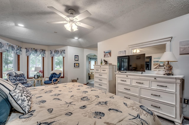 bedroom featuring a textured ceiling and ceiling fan