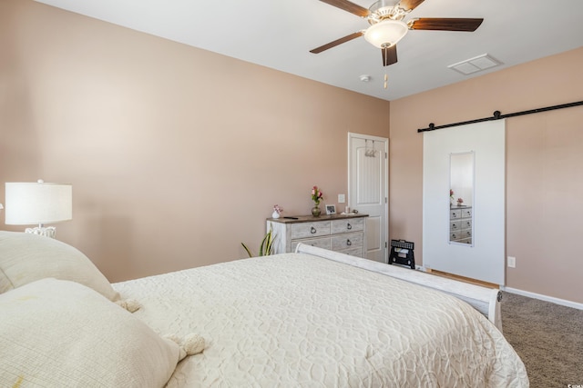 263 Red Maple Loop, Longs, SC 29568 - bedroom with a barn door, carpet, visible vents, a ceiling fan, and baseboards