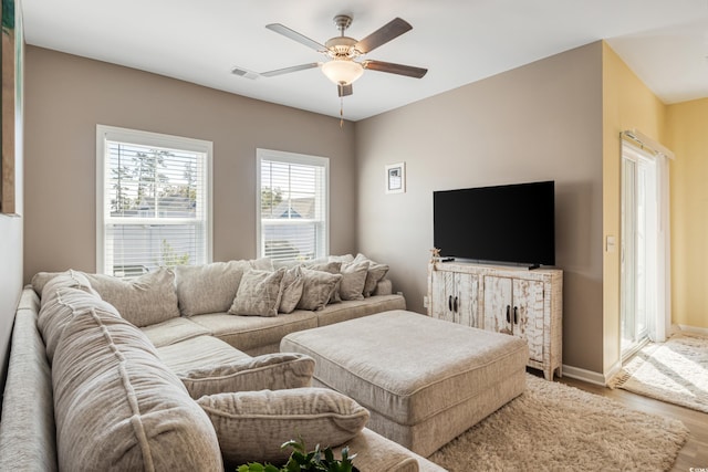 living room featuring hardwood / wood-style flooring and ceiling fan