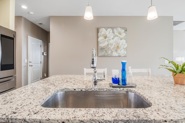 263 Red Maple Loop, Longs, SC 29568 - kitchen with a sink, fridge, visible vents, light stone counters, and decorative light fixtures