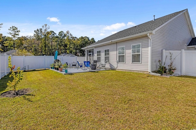 rear view of property featuring a yard and a patio