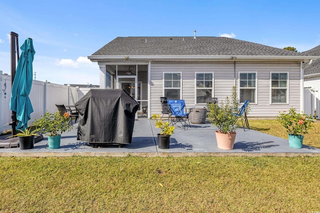 back of house featuring a lawn and a patio area