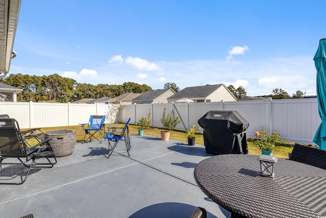 view of patio / terrace with a grill and a fire pit