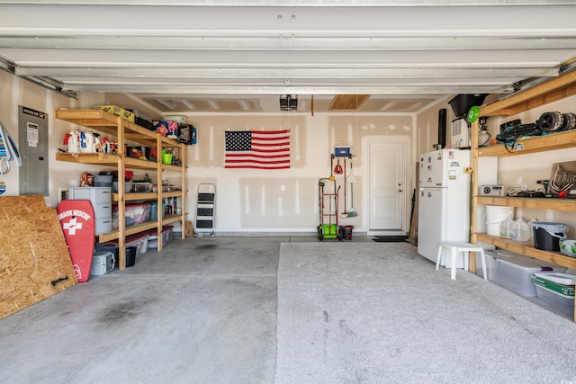 263 Red Maple Loop, Longs, SC 29568 - garage with a garage door opener, electric panel, and freestanding refrigerator
