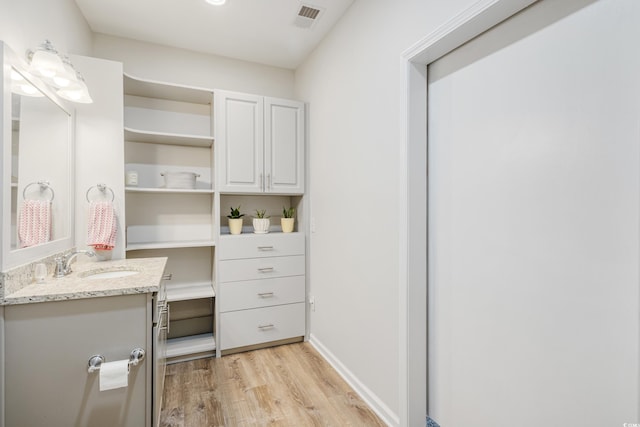 walk in closet featuring sink and light hardwood / wood-style floors