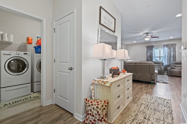 laundry room featuring ceiling fan, wood-type flooring, and independent washer and dryer