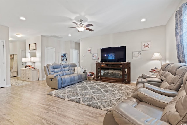 living room featuring ceiling fan and light wood-type flooring