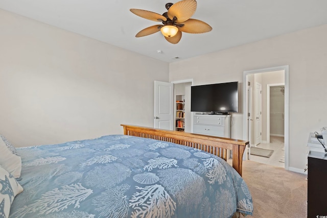 carpeted bedroom with ceiling fan, a spacious closet, and a closet