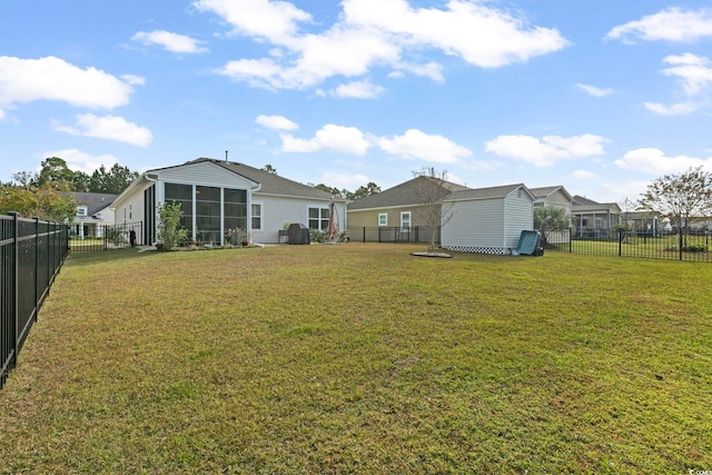 view of yard with a sunroom and a shed