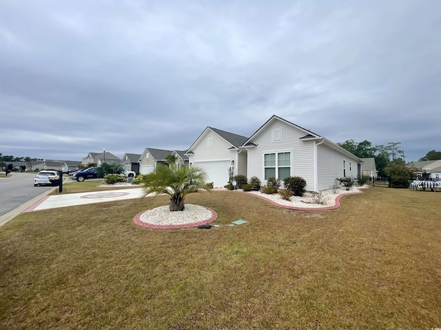 view of front of home featuring a garage and a front yard