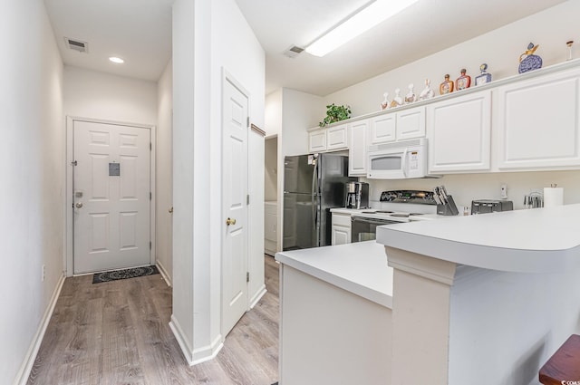 kitchen featuring white cabinets, white appliances, kitchen peninsula, and light hardwood / wood-style flooring