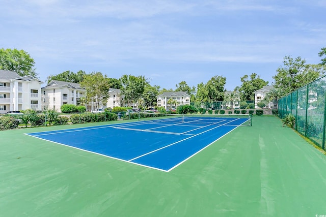 view of tennis court featuring basketball hoop