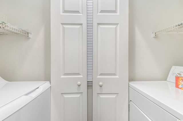 clothes washing area featuring washer and clothes dryer