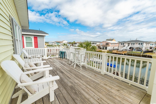 wooden terrace featuring a water view