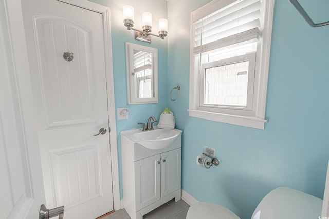 bathroom featuring vanity and toilet