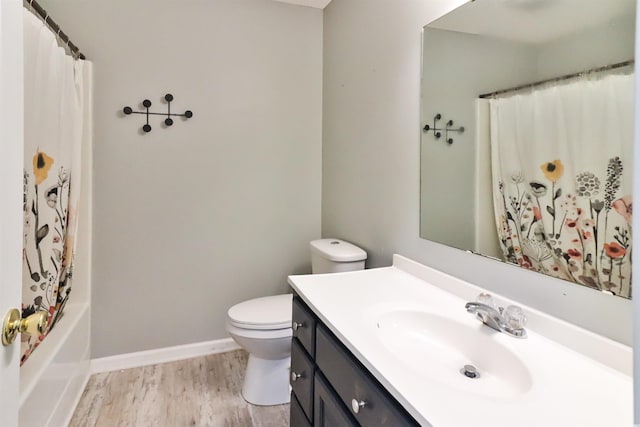 full bathroom featuring shower / tub combo with curtain, vanity, wood-type flooring, and toilet